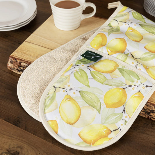 A pair of double oven gloves with a lemon design, displayed on a wooden surface.