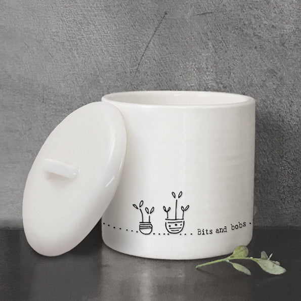 Bits and Bobs white pot with lid on the left side and grey background