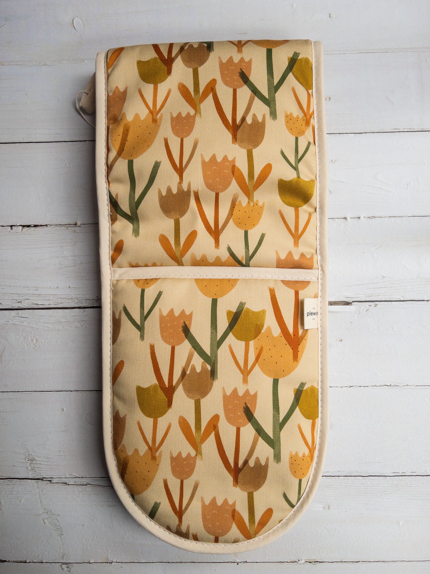 Cream Tulip Oven Glove on a White Wood Background