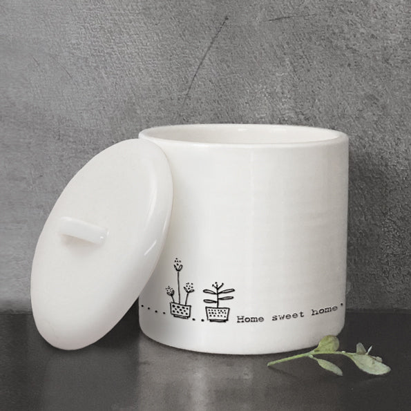 home sweet home white pot with lid on the left side and grey background
