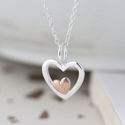 silver and rose gold heart necklace hanging