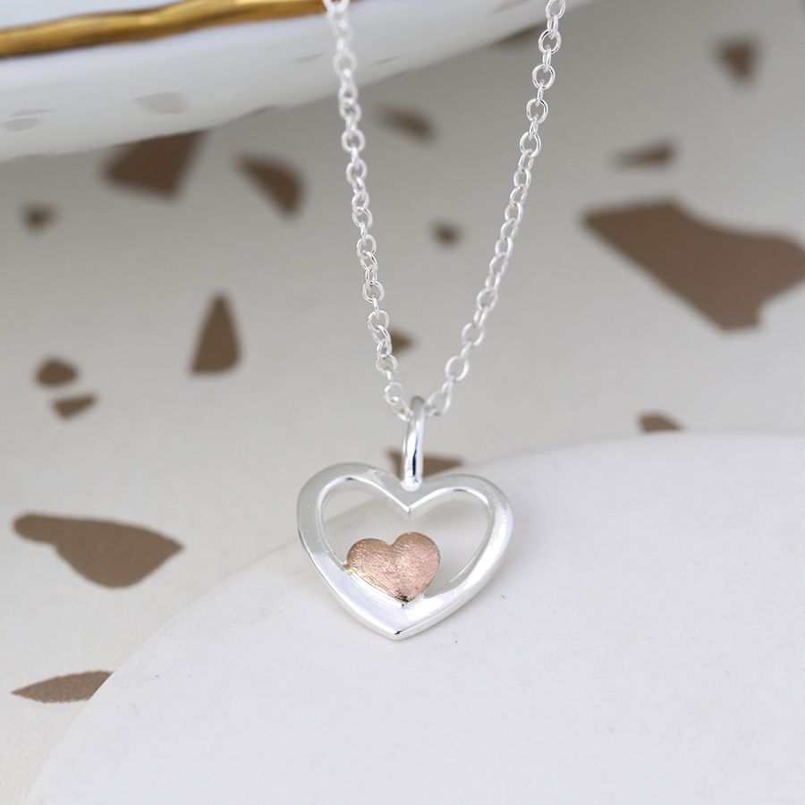 silver and rose gold necklace on it's side 