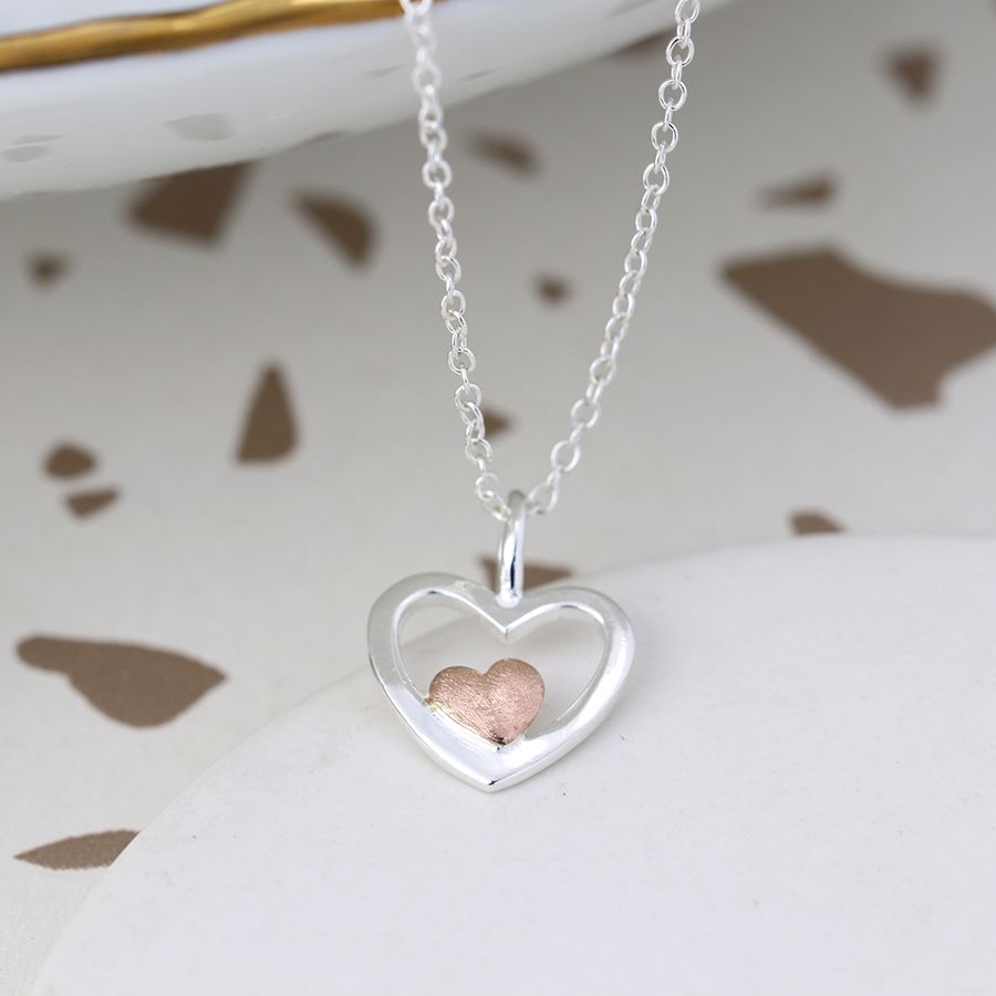 silver and rose gold necklace on it's side