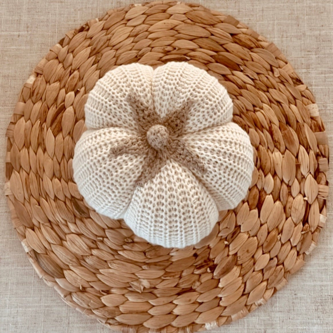 small white pumpkin on a rattan coaster