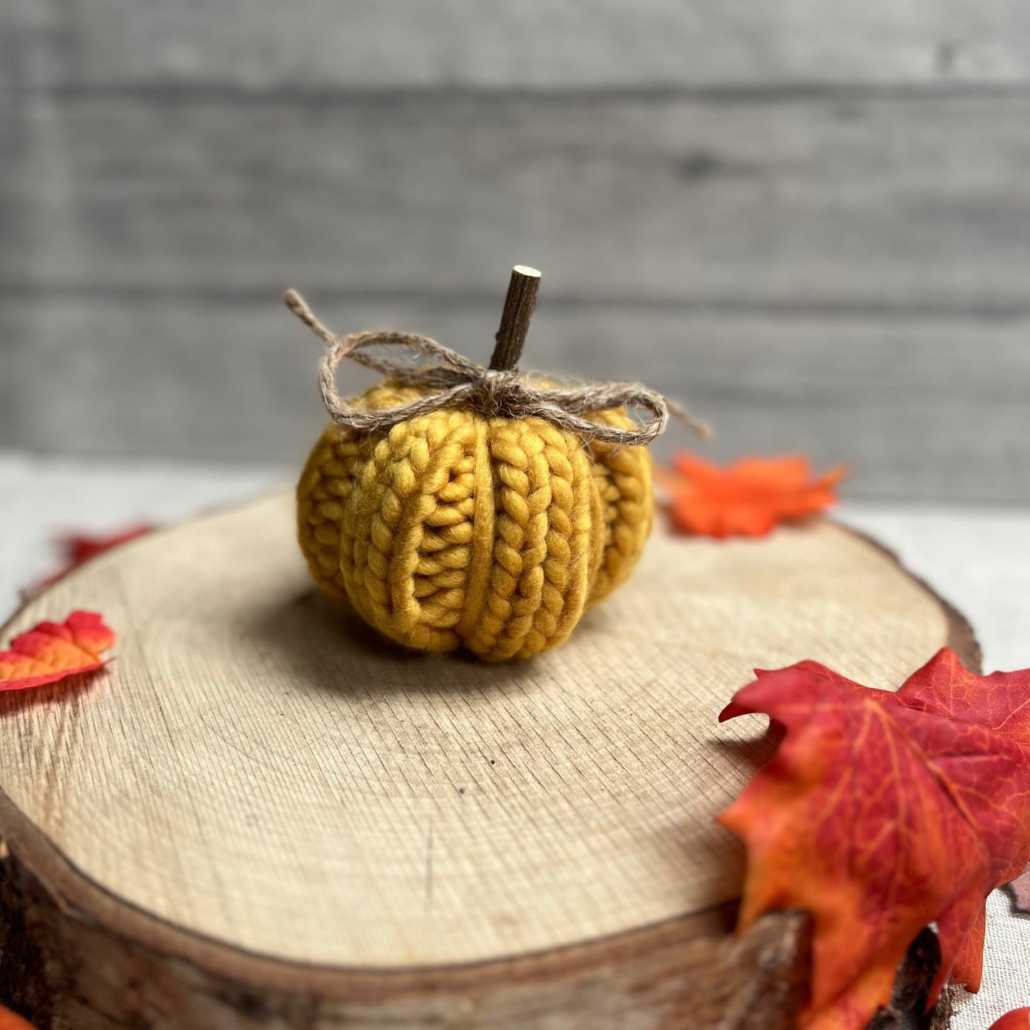 Warm Yellow Knitted Pumpkin with Wooden Stem