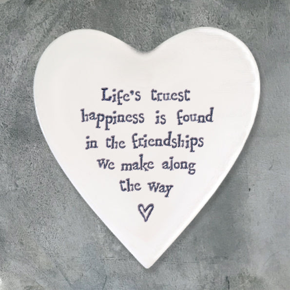 Life's Truest Happiness Quote on white coaster and grey background