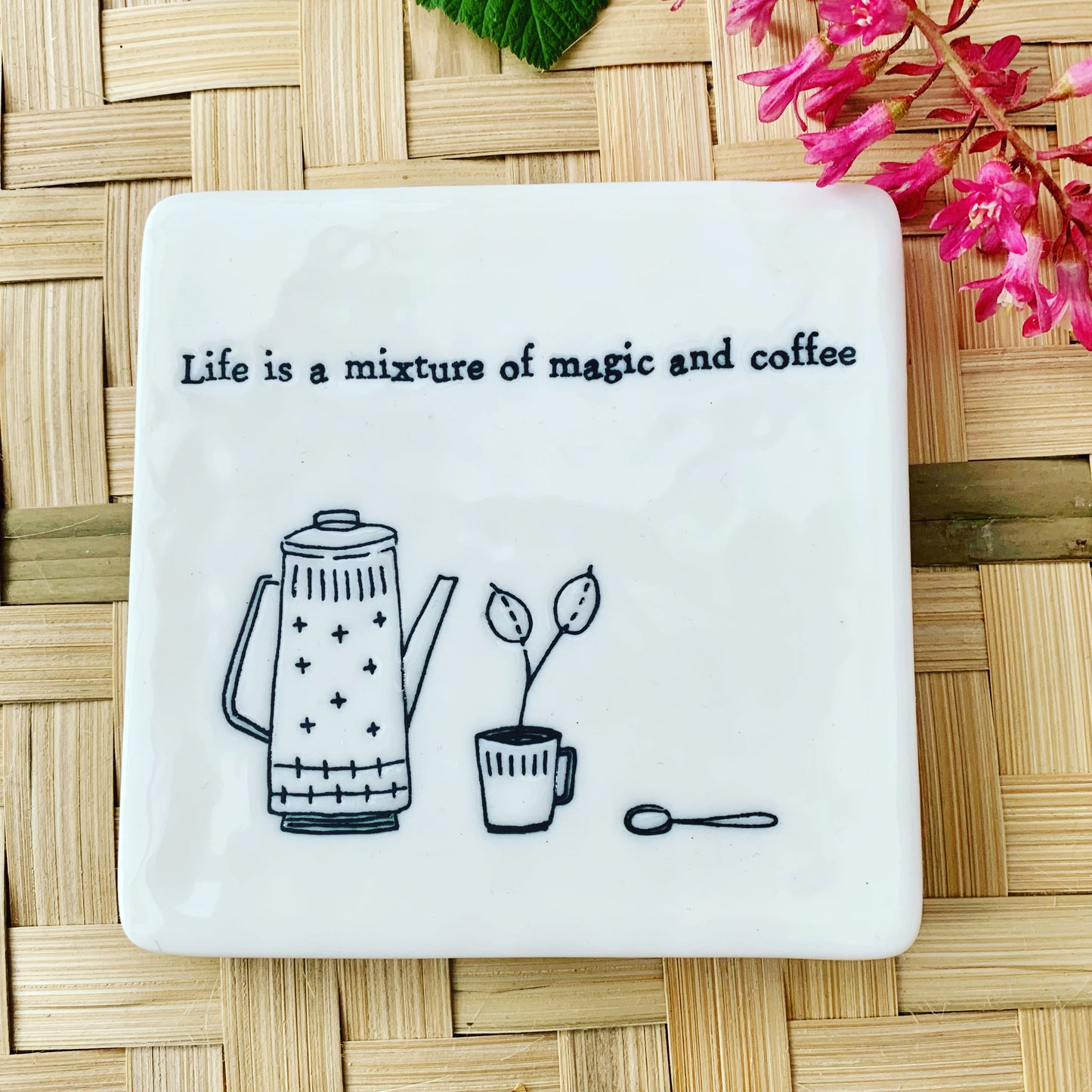 Black and White Porcelain Coffee Themed Coaster with rattan and flower background