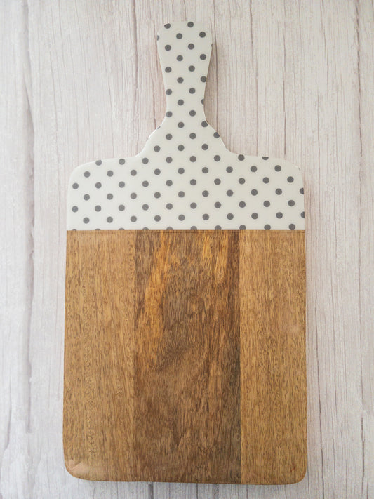 Grey and White Polka Dot Mango wood chopping board on a white wooden background