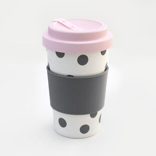 Black and white polka dot travel cup with pink lid