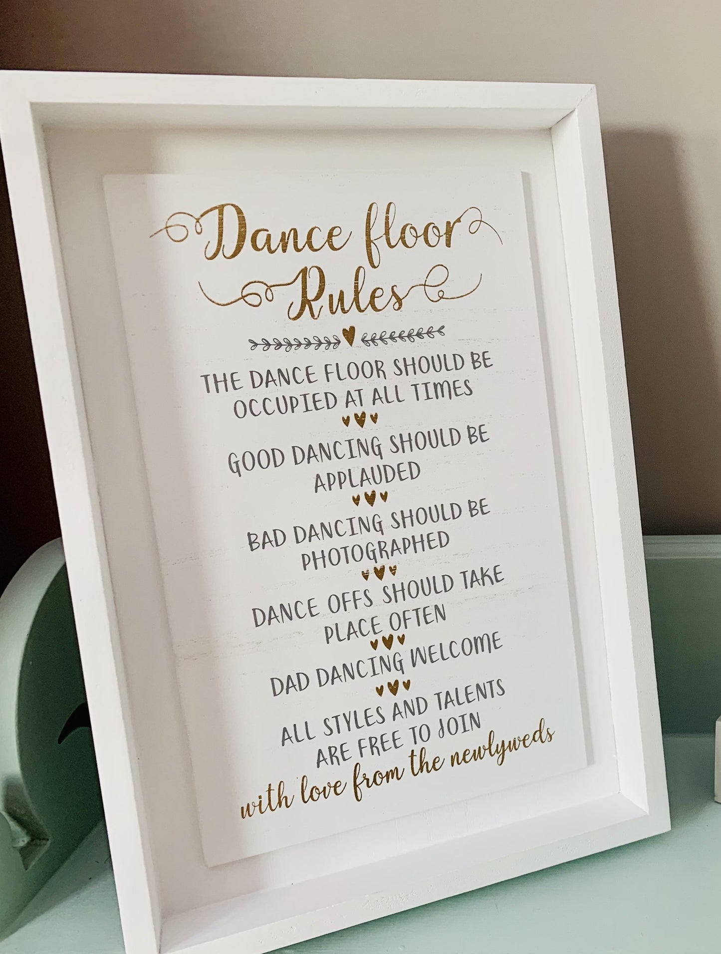 Wedding themed dance floor sign and countdown sign on shelf