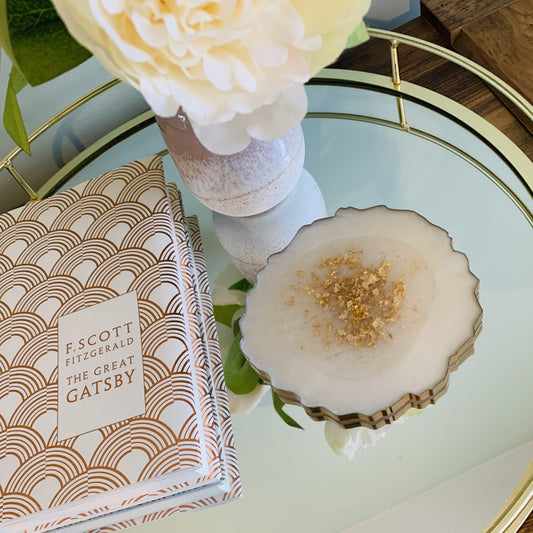 White and Gold coaster on mirror plate with book