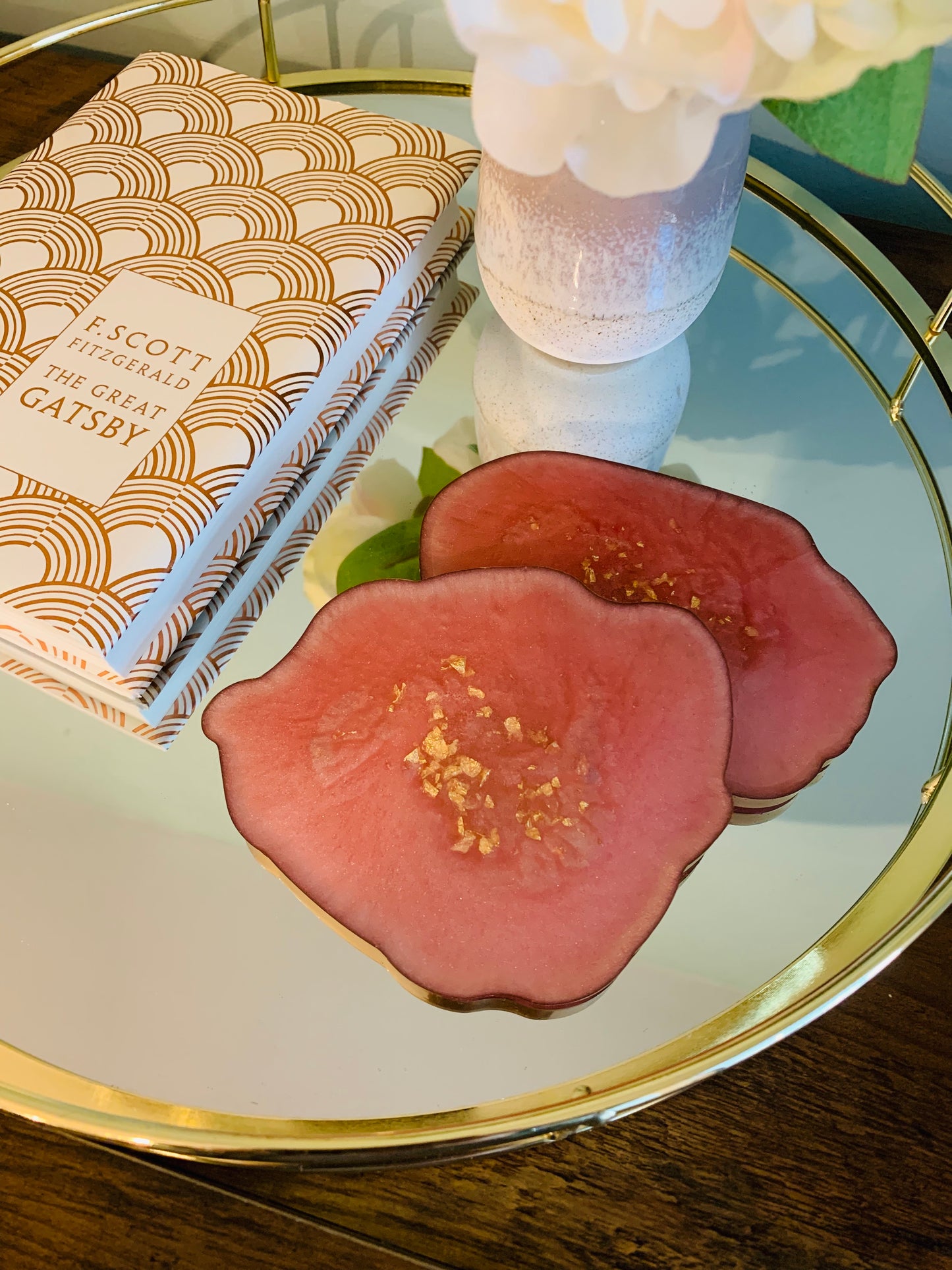 pink and gold resin coaster on a mirror tray