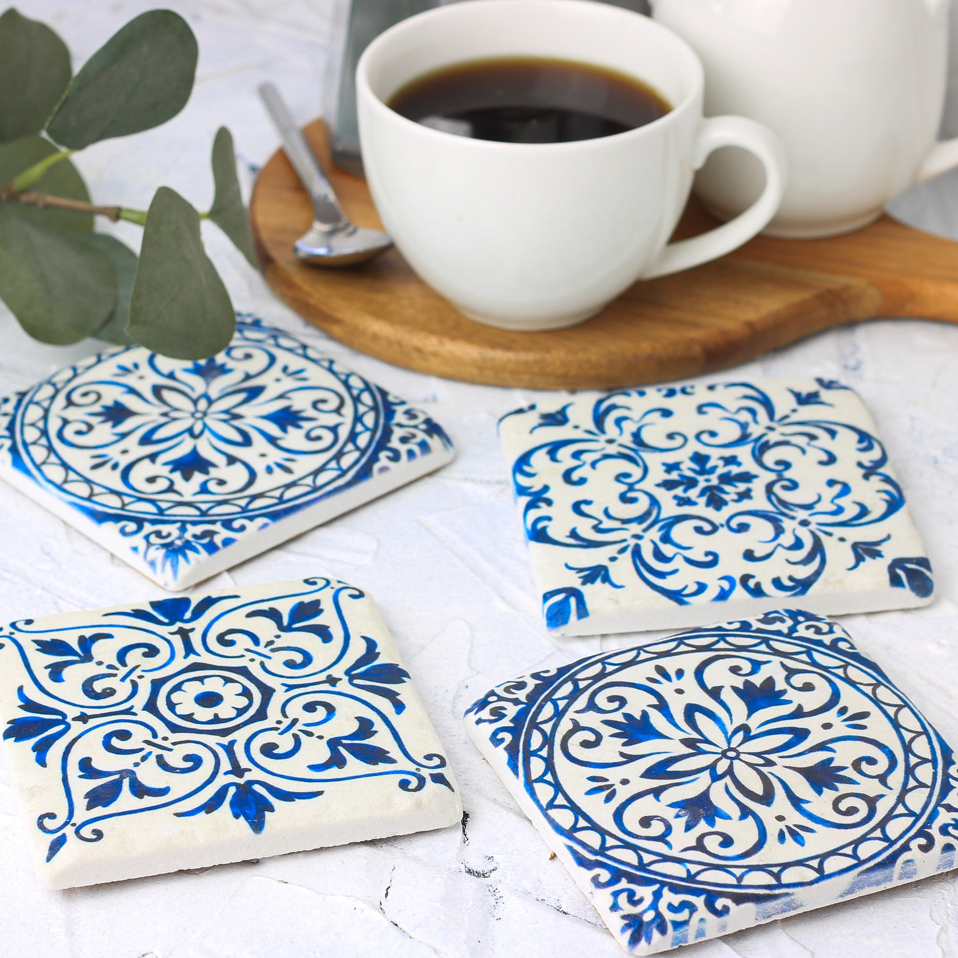 blue and white mediterranean coasters with coffee