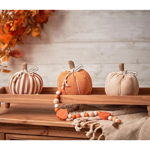warm snug and cosy pumpkins on wooden tray