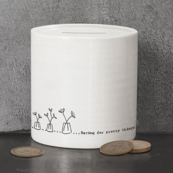 saving for pretty things white moneybox with grey stone background